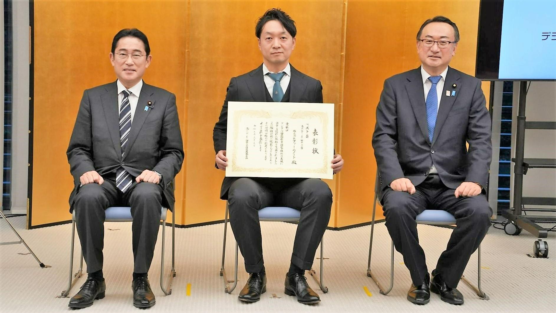 表彰状を掲げる下村瑛史ファームノート代表。左は岸田文雄首相